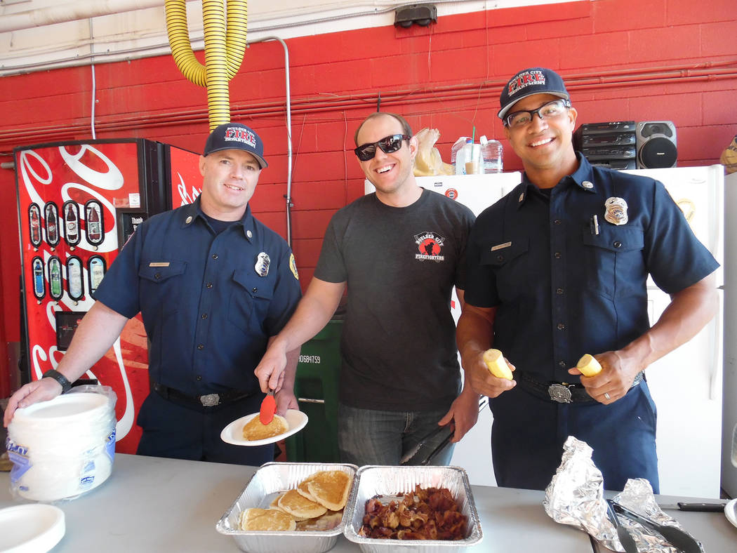 Boulder City Firefighters, from left, Mike Gabiola, Nick Giles and Harold Hadley were among those dishing up pancakes, bacon and bananas last year when the department held its annual pancake break ...