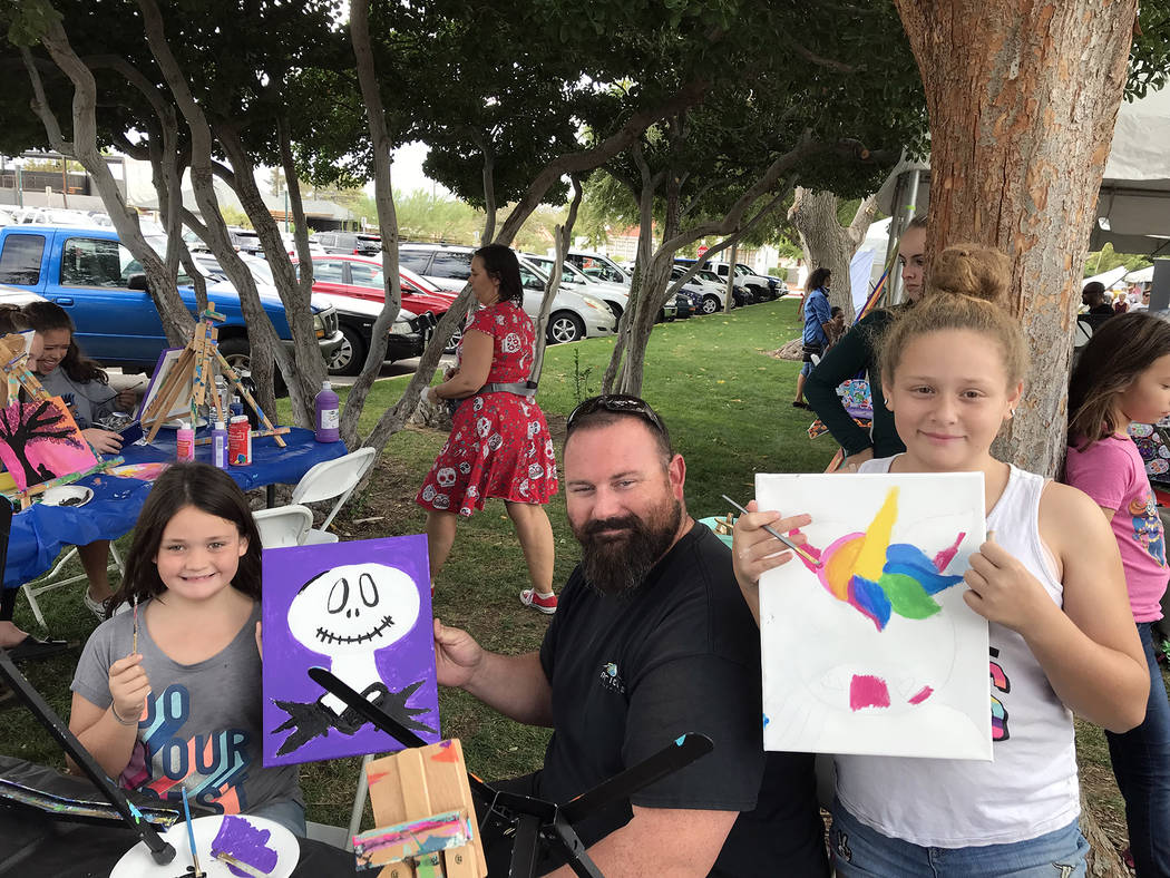 Hali Bernstein Saylor/Boulder City Review Art in the Park offered attendees the chance to create their own works. Here, Boulder City residents Braylin Bagley, 7, from left, Paul Bagley and Mikayla ...