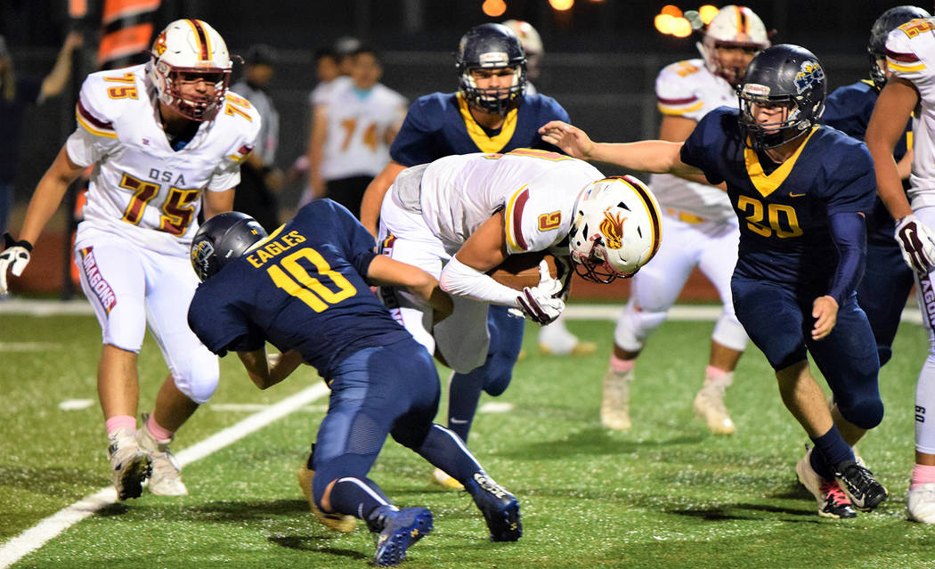 (Robert Vendettoli/Boulder City Review) Boulder City High School sophomore Matt Felsenfeld, left, and senior Jimmy Dunagan close in on the Del Sol ball carrier Oct. 25, 2018. The Eagles came from ...