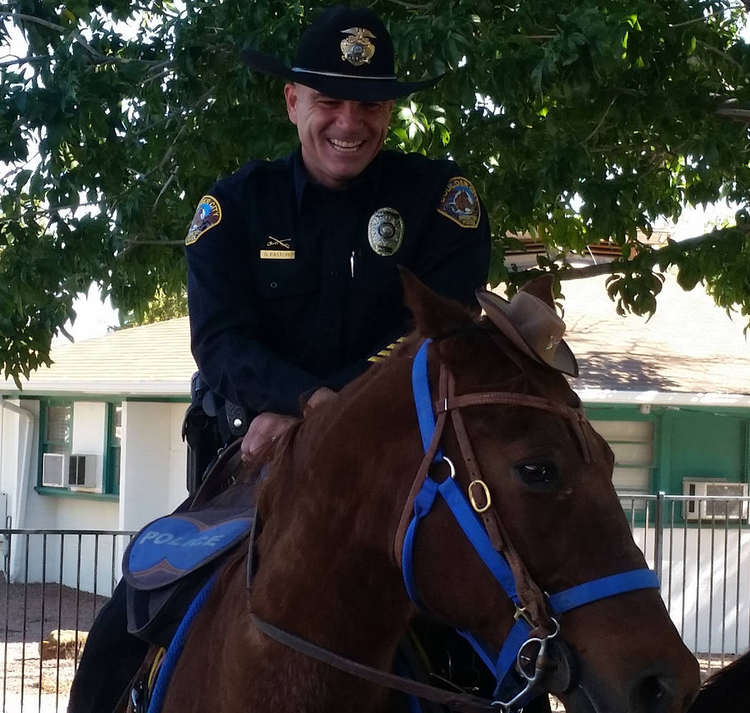 (Celia Shortt Goodyear/Boulder City Review) Boulder City Police Officer Scott Pastore chuckled at Odie's reaction to his new hat during a presentation on Wednesday, Oct. 31, to students at Grace C ...