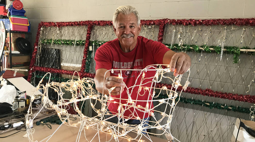 (Hali Bernstein Saylor/Boulder City Review) Dale Ryan tests the light bulbs on a sleigh that was given to him to use in the massive holiday display he creates at his home at 1525 Fifth St. This ye ...