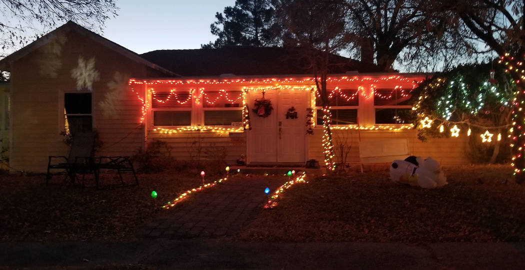 (Celia Shortt Goodyear/Boulder City Review) A house on Ash Street features Christmas lights of different color and revolving snowflakes.