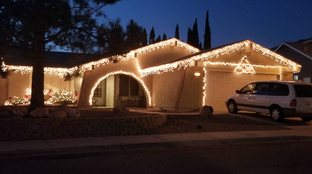 (Celia Shortt Goodyear/Boulder City Review) This house on the 700 block of Christina Drive has a Christmas light display of white lights and red bows.