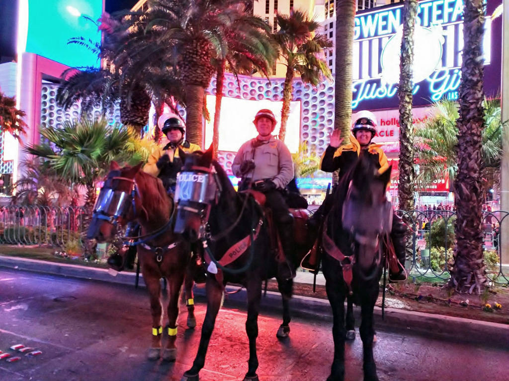 (Scott Pastore) Boulder City Police Department officer Scott Pastore, left, and his horse, Odie assist Metropolitan Police Department officers Mike Torsiello and Maile Hanks on the Strip on New Ye ...