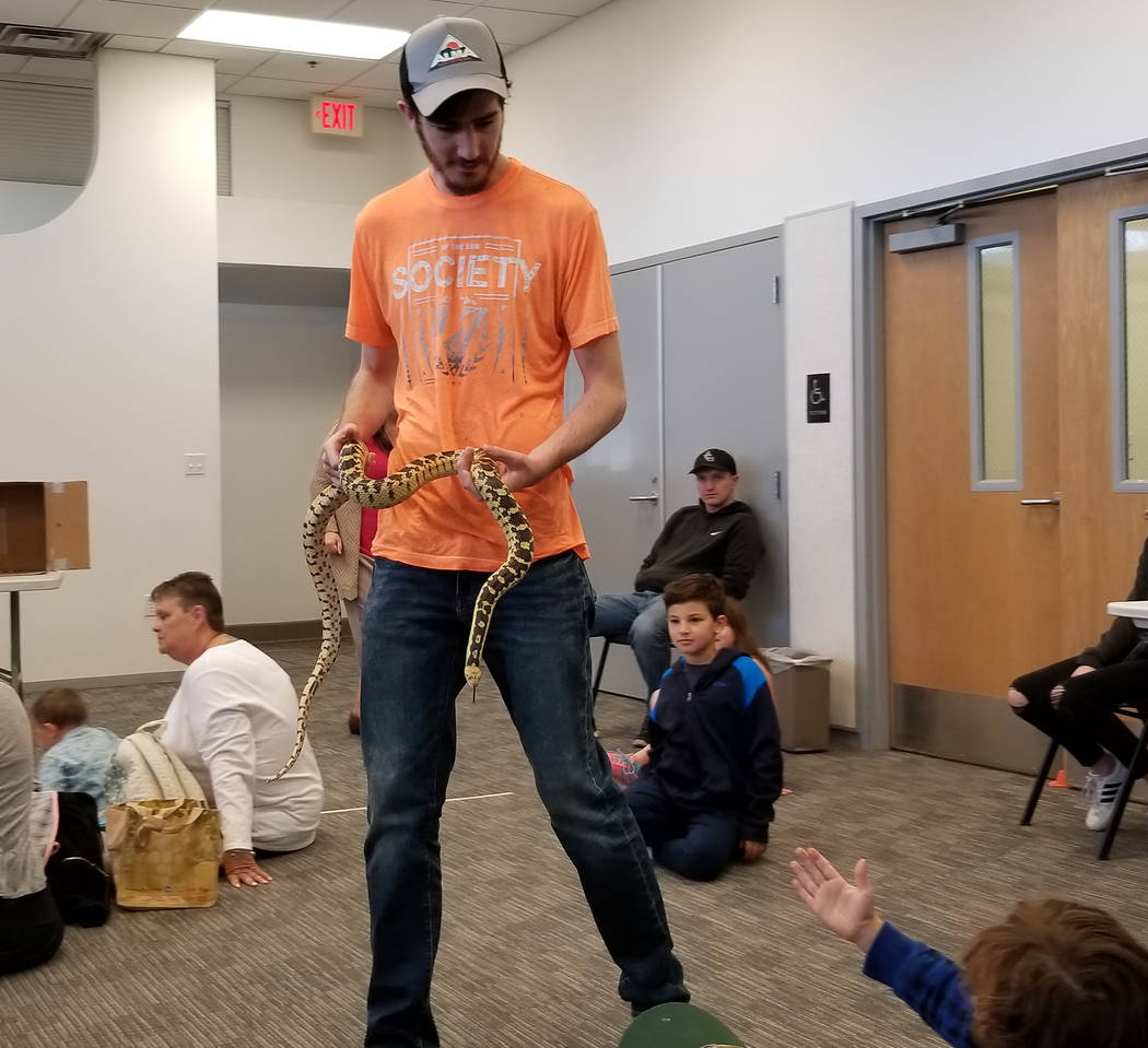 (Celia Shortt Goodyear/Boulder City Review) Garrett Meyer shows off one of his dad's gopher snakes at the Boulder City Library on Thursday, Jan. 3, as part of the winter reading program's activities.