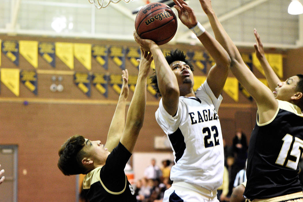(Robert Vendettoli/Boulder City Review) Heavily defended, senior forward Derrick Thomas attempts a put-back layup against Sunrise Mountain onTuesday, Feb. 12, 2019, in the Eagles' 72-40 victory.