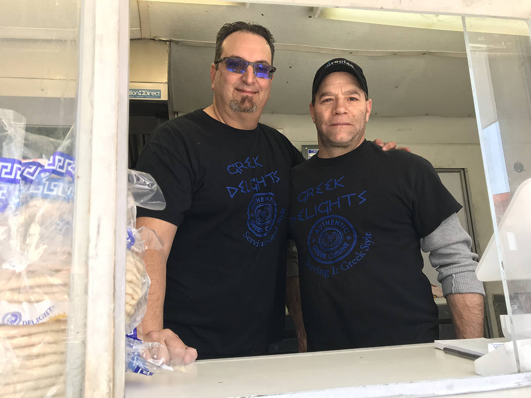 (Hali Bernstein Saylor/Boulder City Review) Dion Katsoris, left, and John Real serve an assortment of Greek dishes at the Greek Delights food truck at 2Wheels.