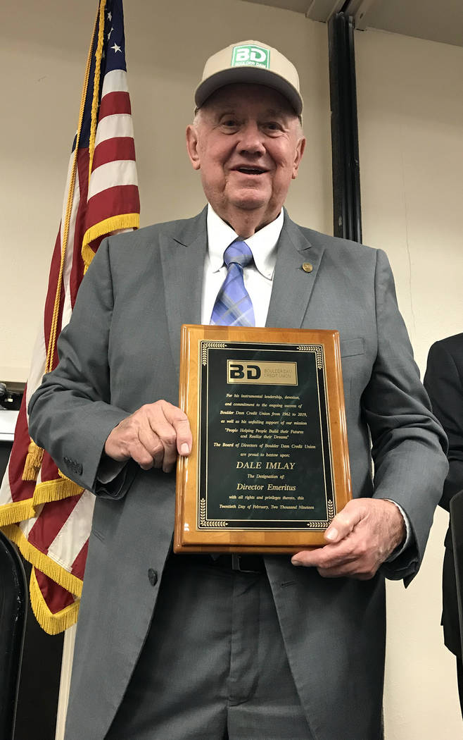 (Hali Bernstein Saylor/Boulder City Review) Dale Imlay shows off his new Boulder Dam Credit Union baseball cap and plaque denoting his new status as the first director emeritus for the financial i ...