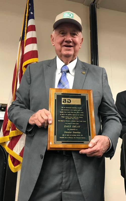 (Hali Bernstein Saylor/Boulder City Review) Dale Imlay shows off his new Boulder Dam Credit Union baseball cap and plaque denoting his new status as the first director emeritus for the financial i ...