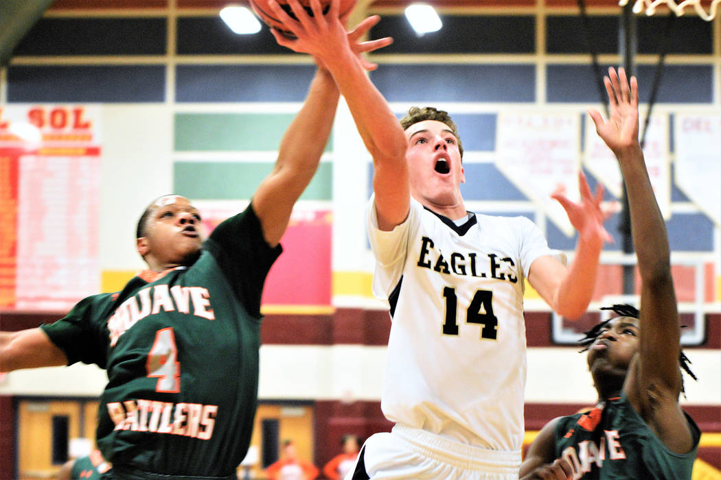 (Robert Vendettoli/Boulder City Review) Fighting through contact, senior forward Karson Bailey drives to the rim for a layup against Mojave in the 3A Southern Region semifinals at Del Sol High Sch ...