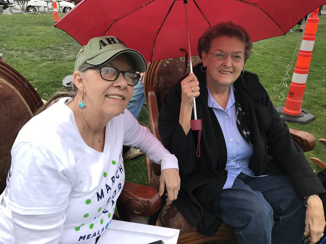 Hali Bernstein Saylor/Boulder City Review Jennie Smith, left, and Jeanne Thompson, volunteers at the Senior Center of Boulder City, didn't let a little rain stop them from rocking in rocking chair ...