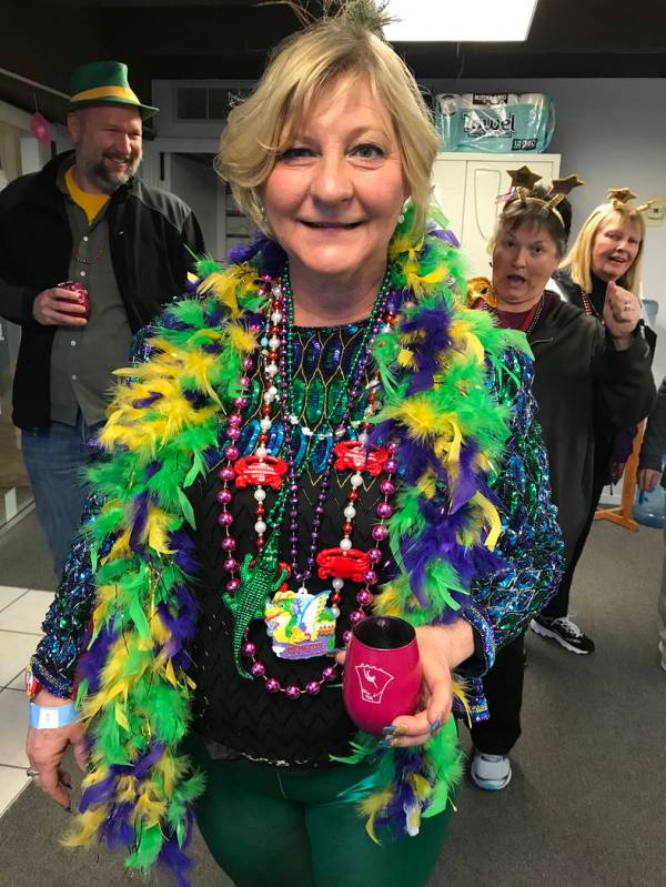 (Hali Bernstein Saylor/Boulder City Review) Lisa Porter Sutter of Henderson shows off her Mardi Crawl outfit featuring attire from Mardi Gras in New Orleans during the Best Dam Wine Walk in downto ...
