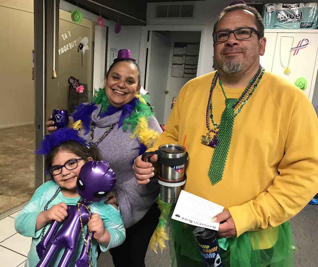 (Hali Bernstein Saylor/Boulder City Review) Vanessa and David Cohen of Boulder City and their daughter, Leora Rose Cohen, dressed in feathers, tutus and beads for Saturday's, March 9, 2019, Mardi ...