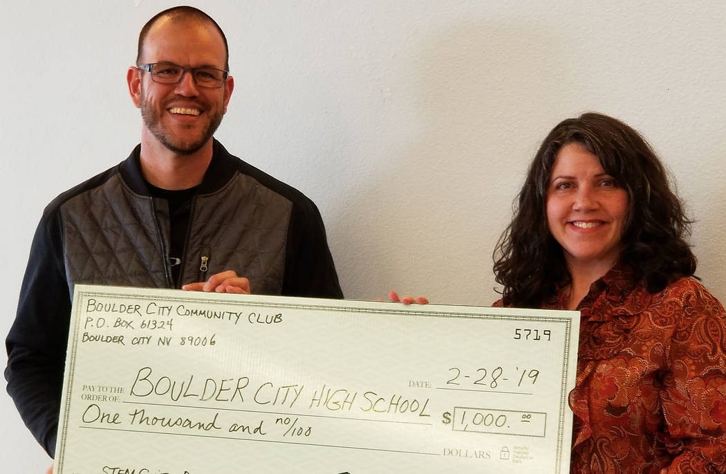 (Boulder City Community Club) Joshua Fisher, who coordinators the STEM guitar program at Boulder City High School, accepts at $1,000 donation from the Boulder City Community Club Treasurer Carmela ...