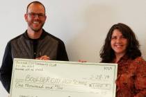 (Boulder City Community Club) Joshua Fisher, who coordinators the STEM guitar program at Boulder City High School, accepts at $1,000 donation from the Boulder City Community Club Treasurer Carmela ...
