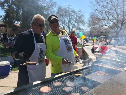 (Hali Bernstein Saylor/Boulder City Review) Dale Ryan, left, and Andy Anderson manned the barbecue grill, cooking hamburgers and hot dogs, at Saturday's, March 16, 2019, Rock, Roll & Stroll to ...