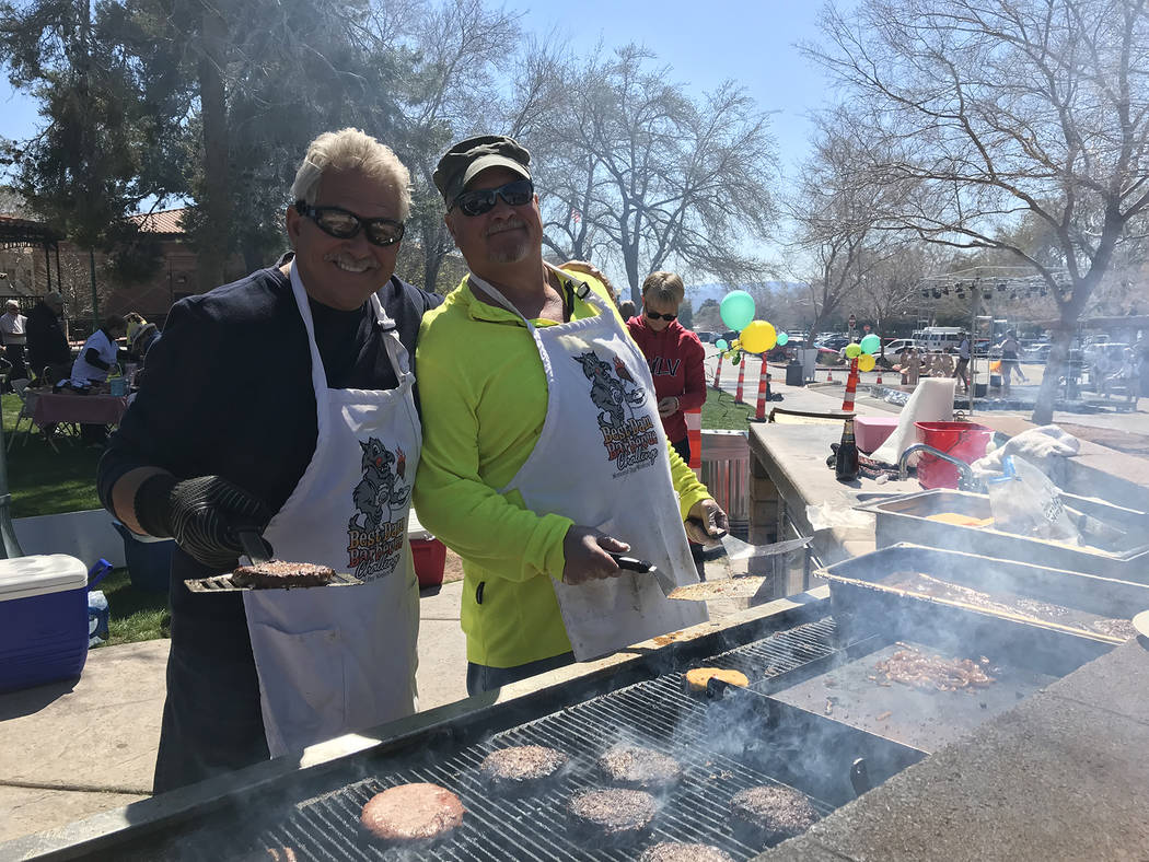 (Hali Bernstein Saylor/Boulder City Review) Dale Ryan, left, and Andy Anderson manned the barbecue grill, cooking hamburgers and hot dogs, at Saturday's, March 16, 2019, Rock, Roll & Stroll to ...