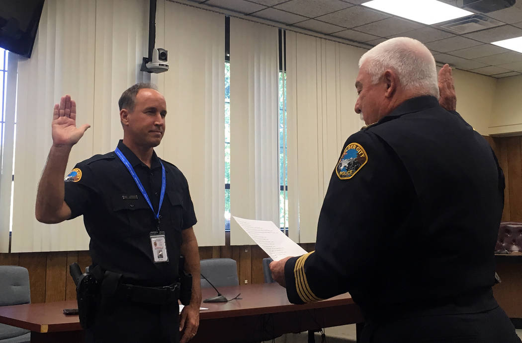 (Boulder City) Boulder City Police Chief Tim Shea, right, swears in new city marshal Michael Kr ...