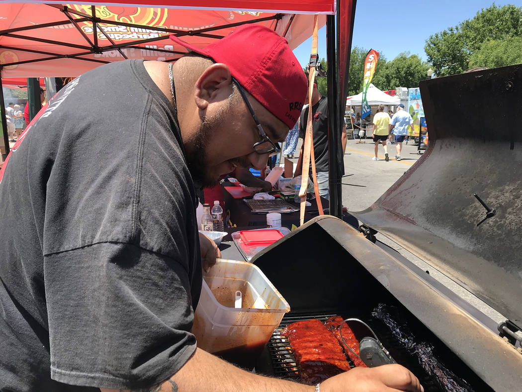 Erik Hernandez of Rollin Smoke Barbeque of Las Vegas puts sauce on his rib entry during the Bes ...