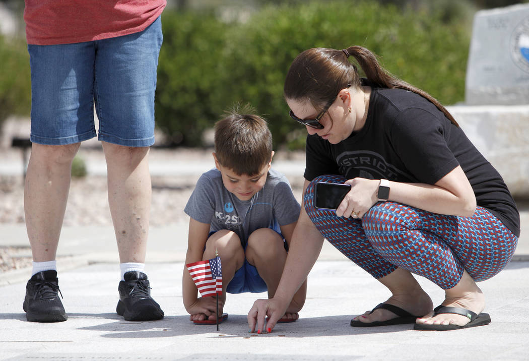 (Rachel Aston/Las Vegas Review-Journal) Sarah Vela helps her son Jace Vela, 5, place a pennies ...