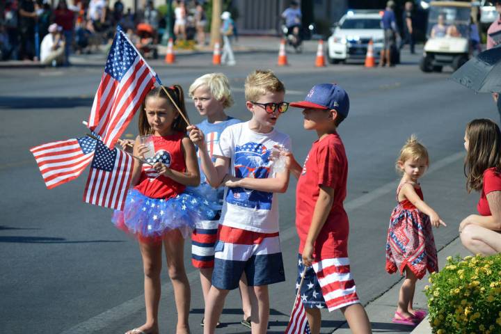 Some of the 70th annual Damboree parade's younger spectators talk in between the floats' arriva ...