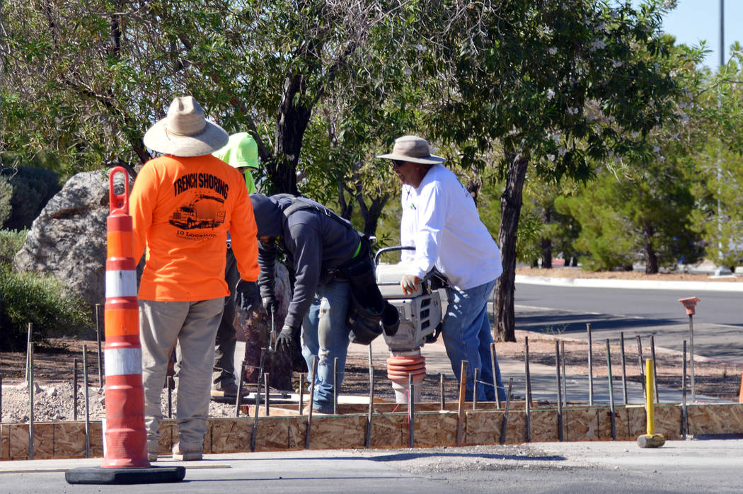 (Celia Shortt Goodyear/Boulder City Review) Workers begin the process of installing new crossin ...