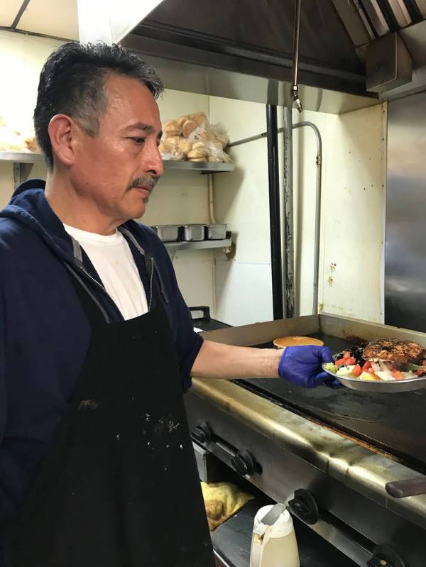 (Hali Bernstein Saylor/Boulder City Review) Jose Bejar, a cook at Southwest Diner, prepares a g ...