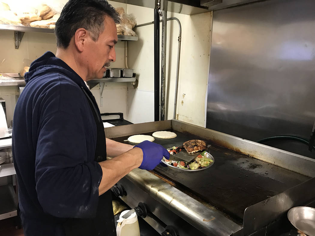 (Hali Bernstein Saylor/Boulder City Review) Jose Bejar, a cook at Southwest Diner, prepares a g ...