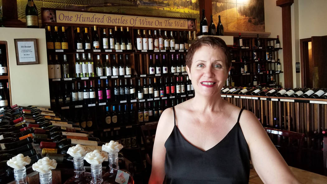 Celia Shortt Goodyear/Boulder City Review Cameron Sisk showcases the 100 bottles of wine availa ...