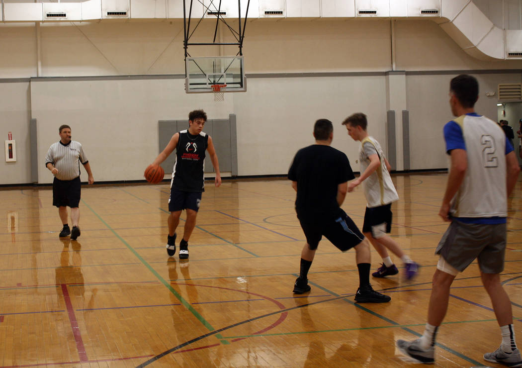 (Kelly Lehr) Nathan Sacco from All Kinds Services brings the ball down the court against Woodbu ...