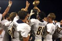 (Amy Wagner) The Boulder City High School varsity football team celebrates its 12-7 road victor ...