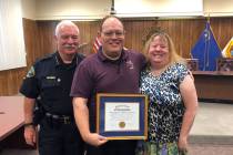 (Boulder City) Bill Avery, center, is honored with OffenderWatch's National Award for Excellenc ...