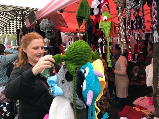 Adar Bagus of Las Vegas looks at handmade hats during Art in the Park in 2018. This year's fest ...