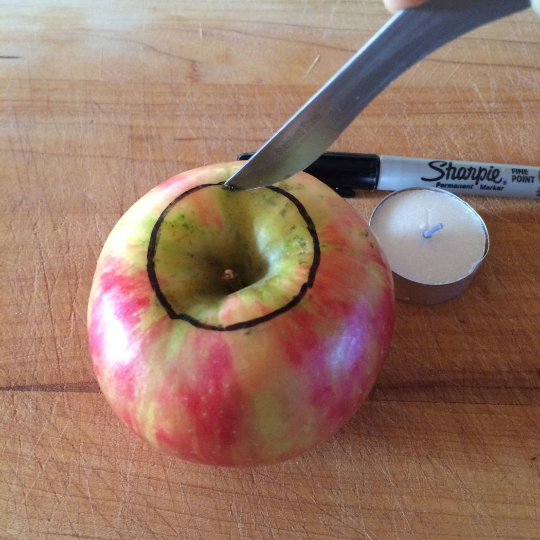 (Norma Vally) To make your own fall-scented candle in an apple, use a marker to trace the diame ...