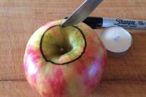 (Norma Vally) To make your own fall-scented candle in an apple, use a marker to trace the diame ...