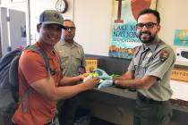 (Hali Bernstein Saylor/Boulder City Review) Noel Tipon, left, of Kailua, Hawaii, accepts a cupc ...