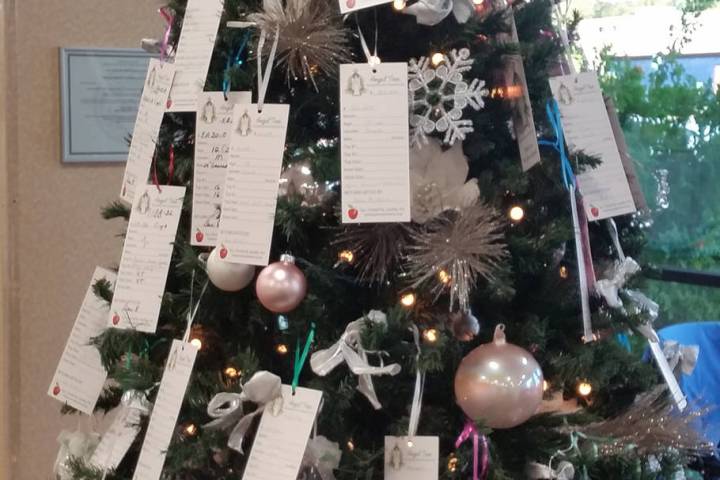 Tags with information about the needs of local children and seniors adorn the Angel Tree set up ...