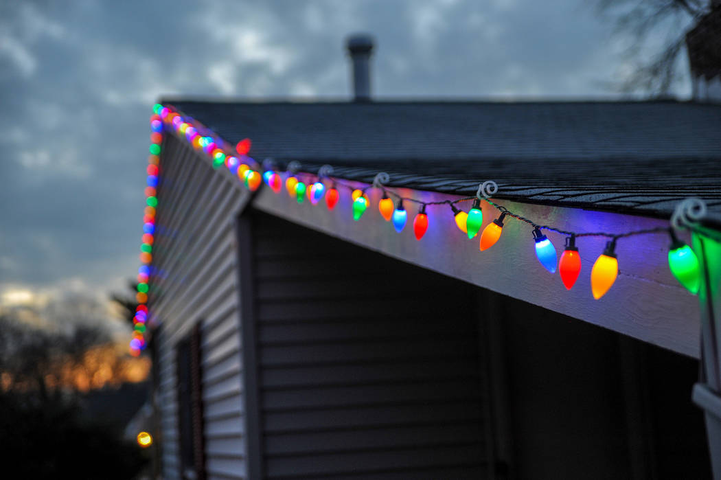 (Norma Vally) When hanging Christmas lights on your home, maintain three-point contact on the l ...