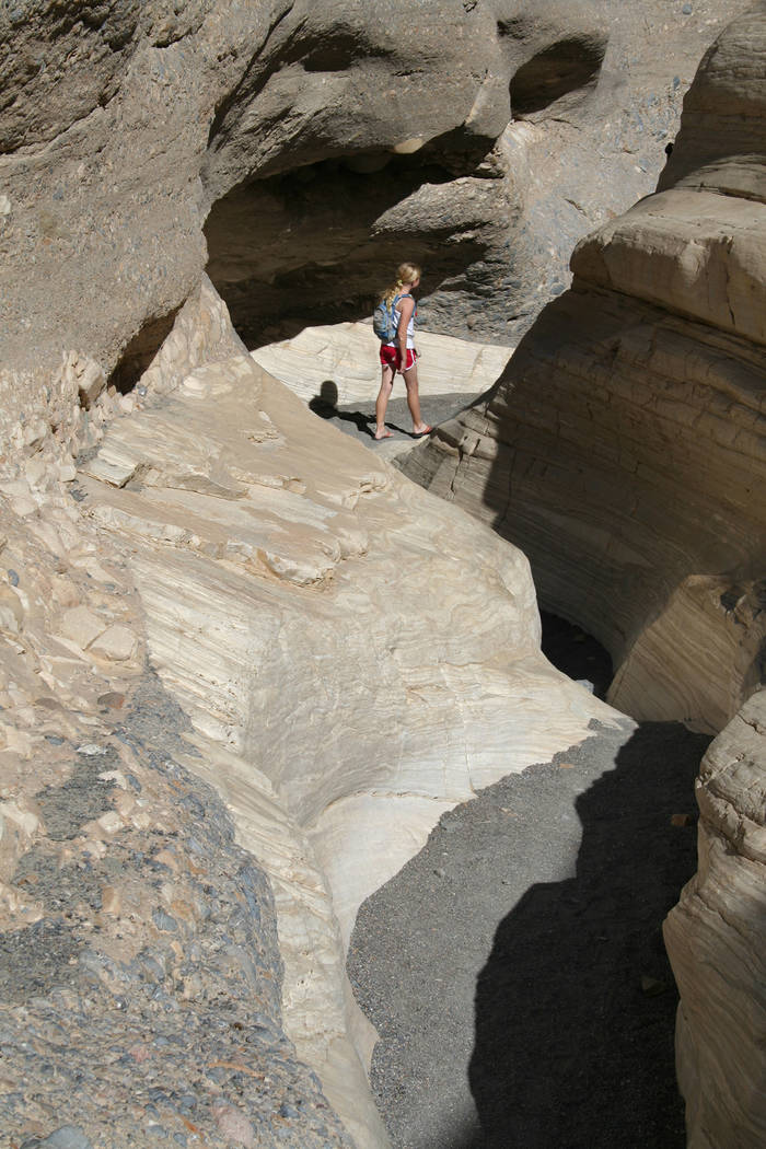 (Deborah Wall) A hiker heads through a narrow section in Mosaic Canyon in Death Valley National ...