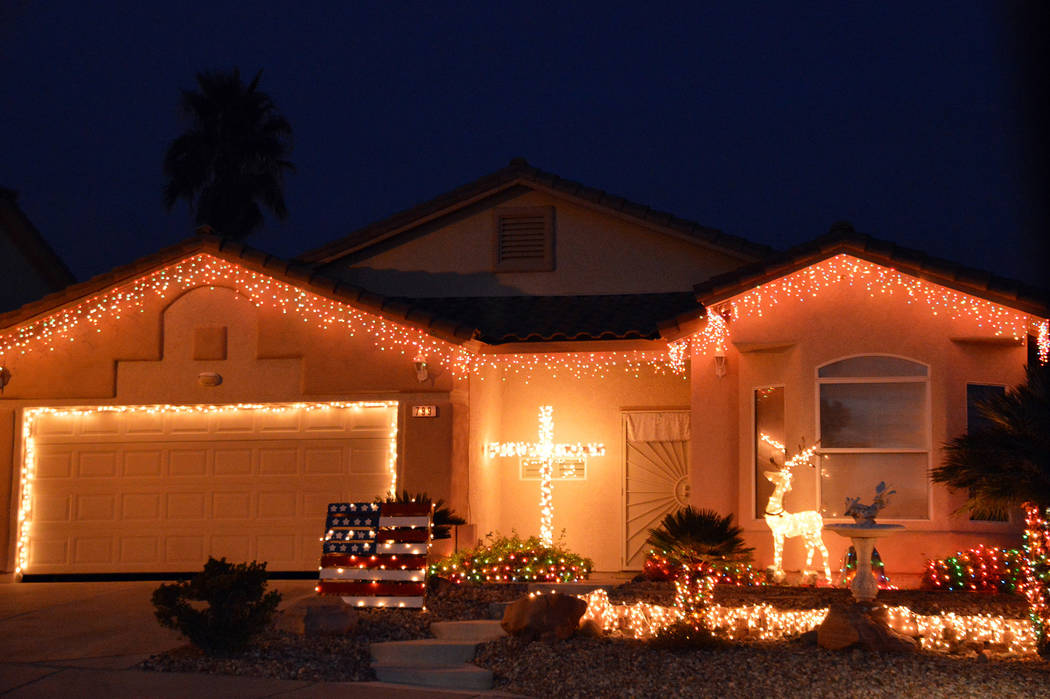 (Celia Shortt Goodyear/Boulder City Review) Twinkling lights along with religious and patriotic ...