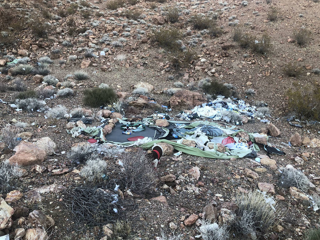(Ed Knapp) The remains of a tent and discarded bottles are among the debris left by homeless pe ...