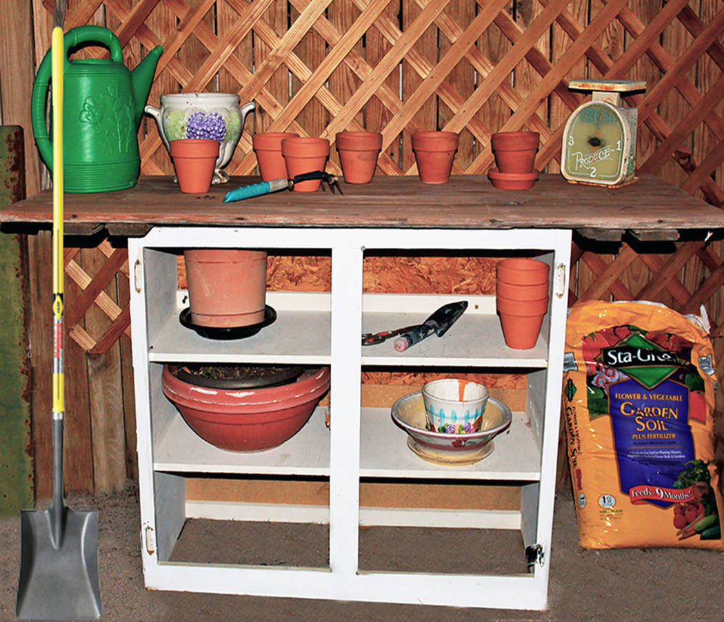 (Norma Vally) An old cabinet with the door removed can be upcycled into a potting table for the ...