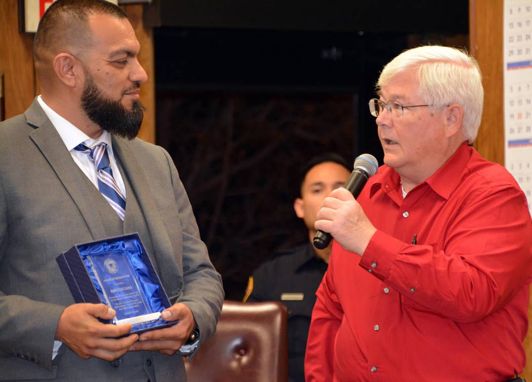 (Celia Shortt Goodyear/Boulder City Review) Marcos Caro, left, is given an award at the Jan. 28 ...