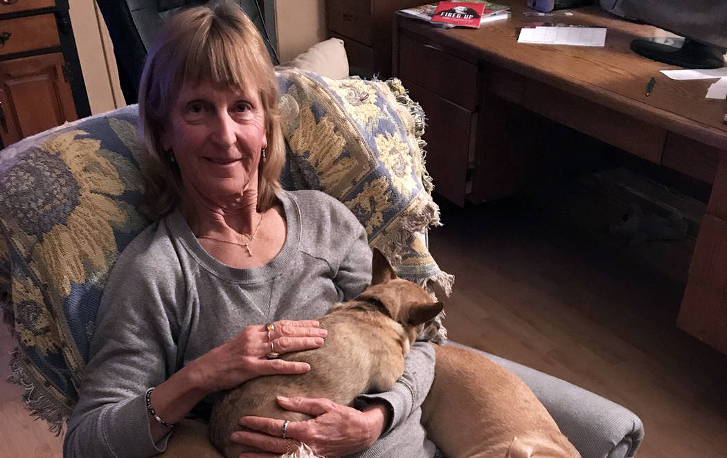 (Sara Carroll) Sara Carroll relaxes at home with a few of the dogs she has adopted from Boulder ...