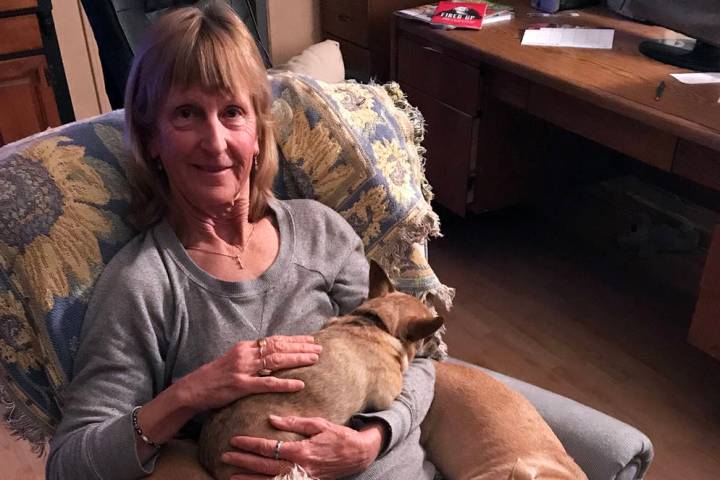 (Sara Carroll) Sara Carroll relaxes at home with a few of the dogs she has adopted from Boulder ...