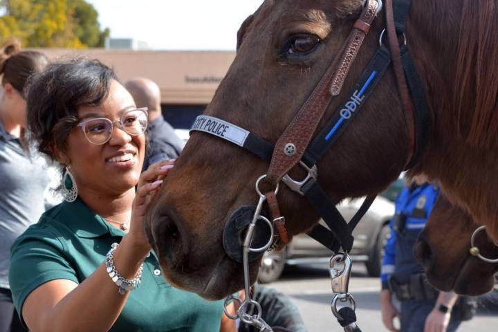 (Celia Shortt Goodyear/Boulder City Review) Dasia Cobb pets Odie during Cops, K-9s and Coffee a ...