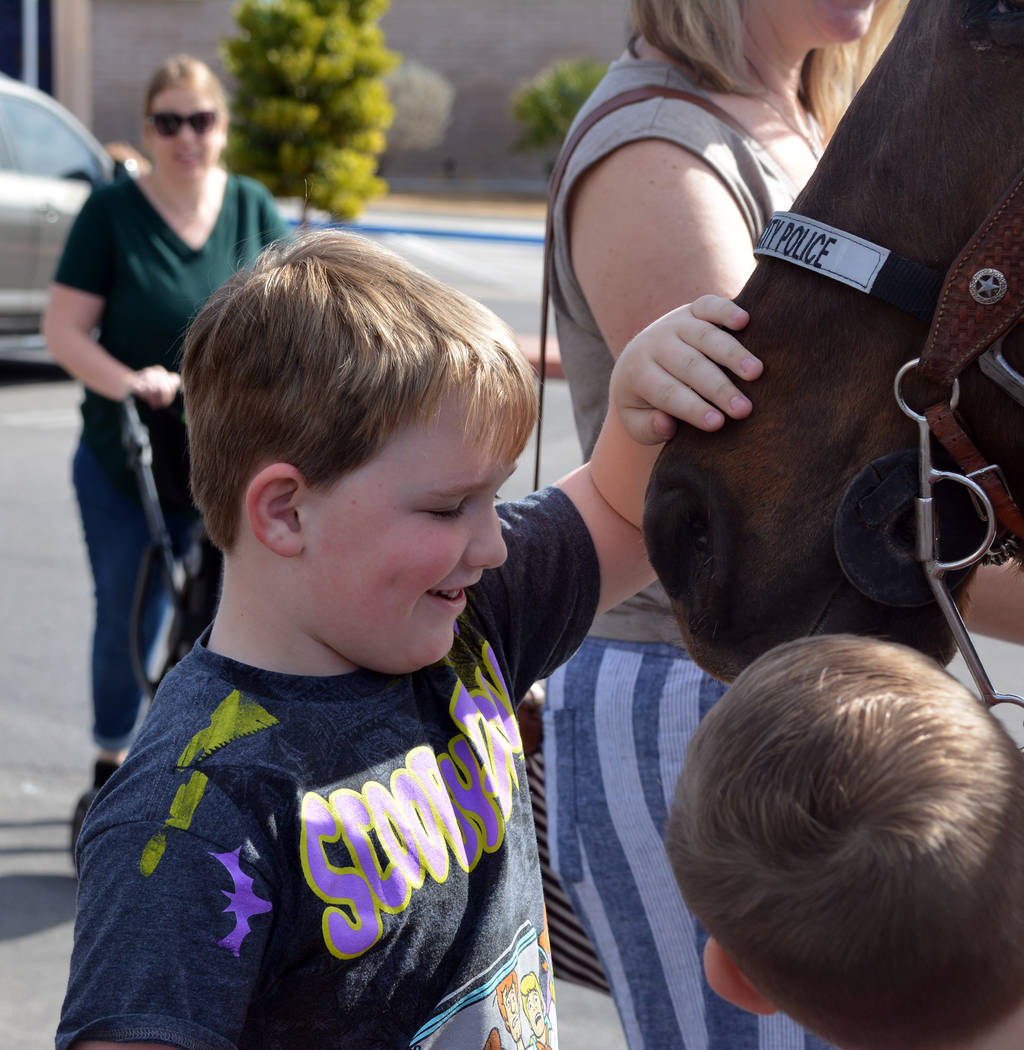 (Celia Shortt Goodyear/Boulder City Review) Jackson Mack pets Star, a horse with the Boulder Ci ...