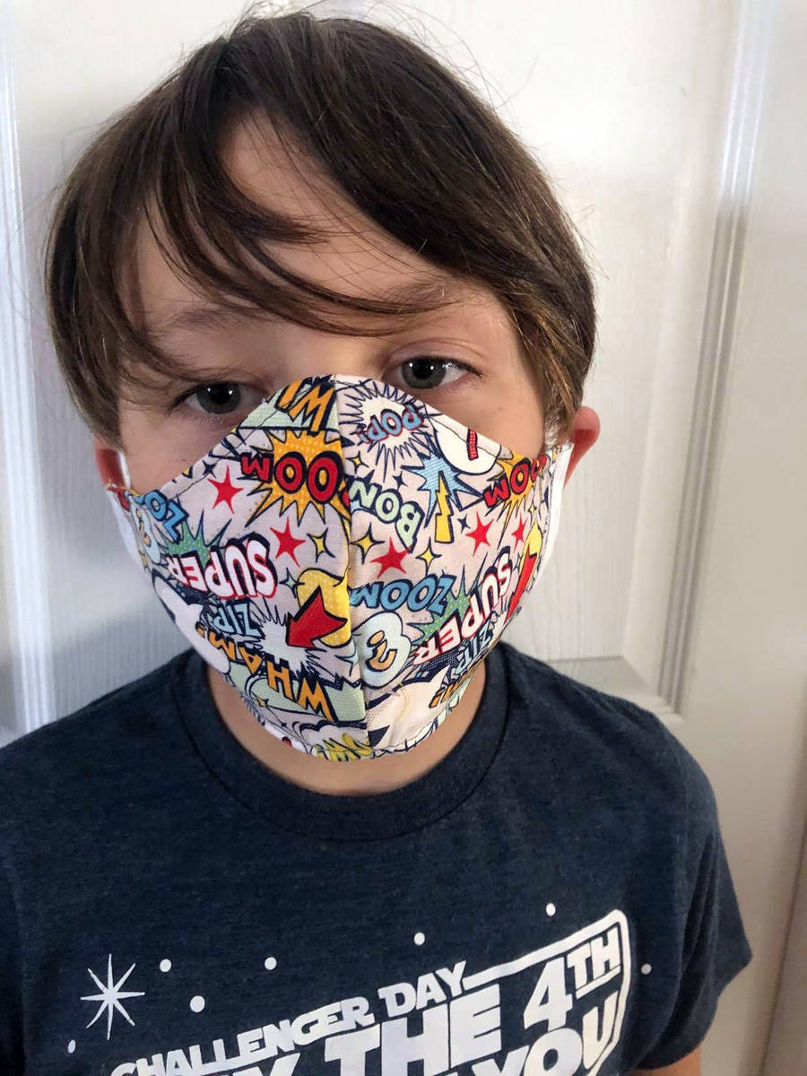 Katie Kilar Eight-year-old Matthew Kilar models a mask that his mom, Katie Kilar, made for heal ...