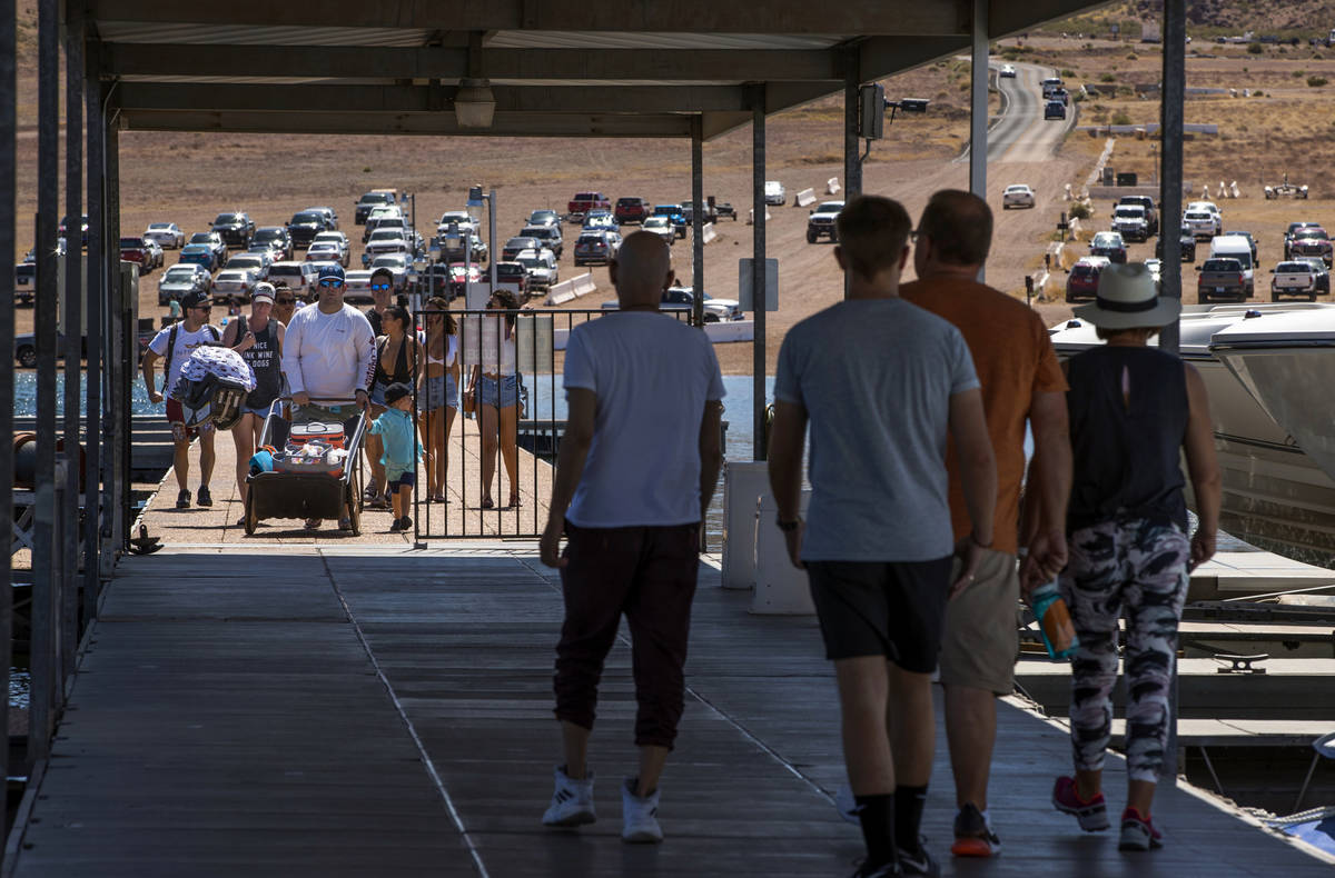 (L.E. Baskow/Las Vegas Review-Journal) Visitors walk on the pier at the Las Vegas Boat Harbor i ...