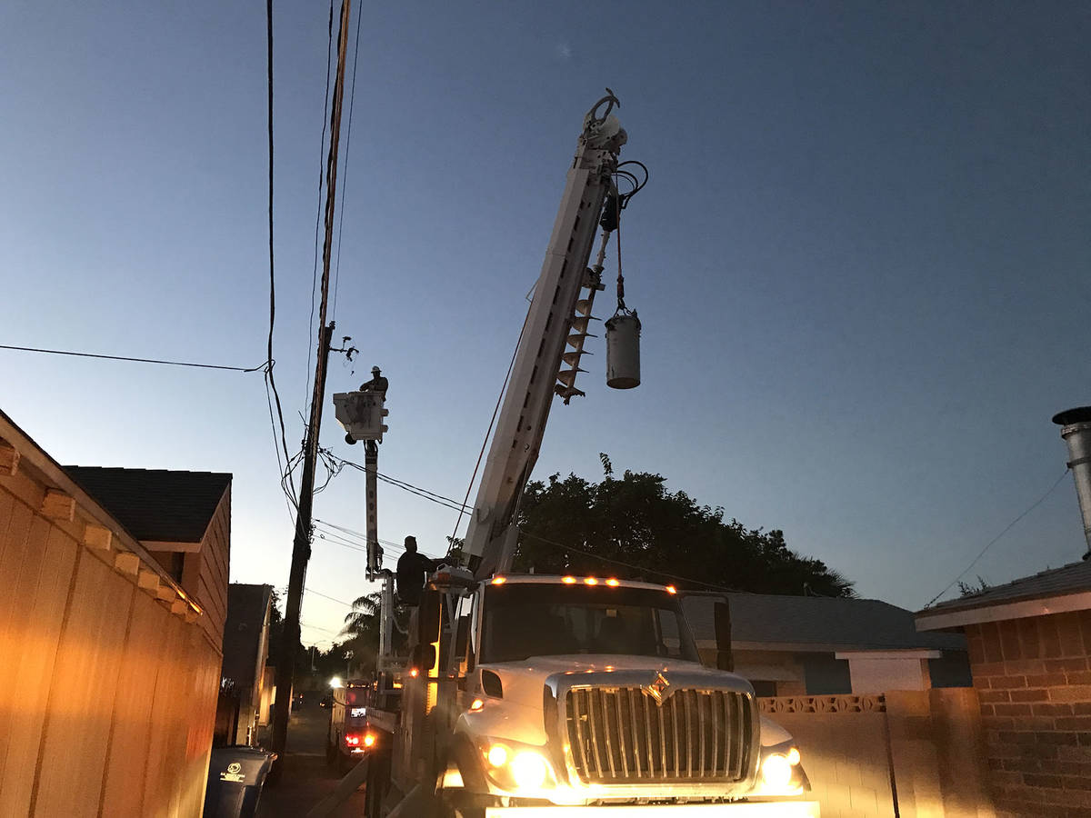 (Norma Vally) A crew from the utility department repairs a transformer “can” that ...